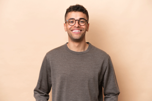 man with glasses smiles in front of wall in honey lake clinic admissions