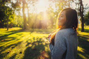 woman in sunlight outdoors in an alumni program