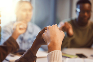 people joining hands in an intensive outpatient program for mental health