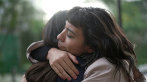 two women hug in a trauma treatment program